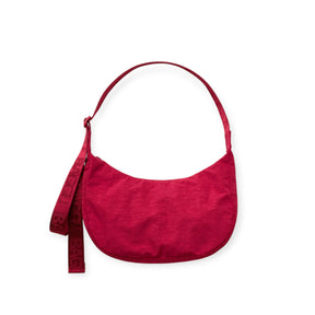 Cherry red nylon crescent bag with top handle and front hanging tag loop
