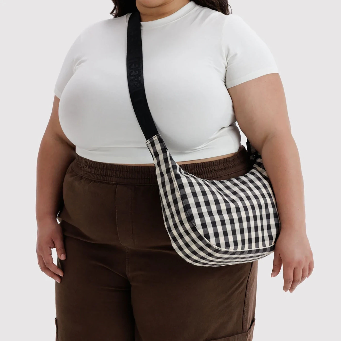 Black and cream gingham crescent crossbody bag with adjustable strap