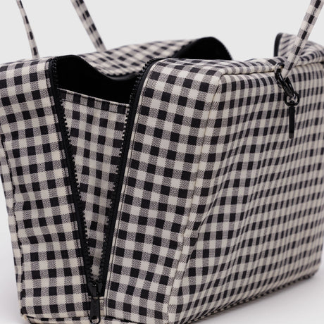 Close-up of an open Baggu Medium Nylon Bowler Bag - Gingham with a black-and-white check pattern and sleek black zipper.
