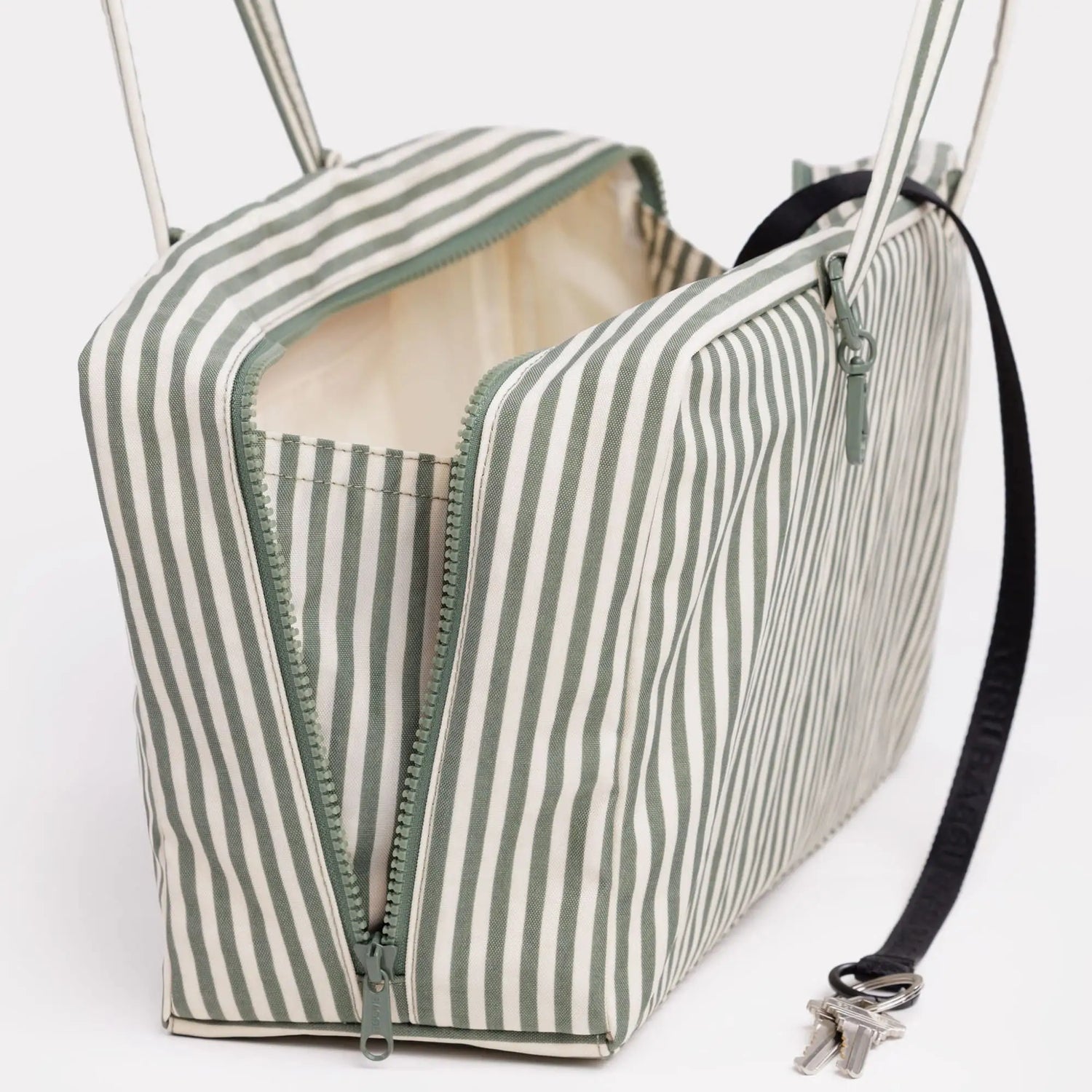 Medium nylon bowler bag with sage green and white stripes, zip top, side pocket, handles