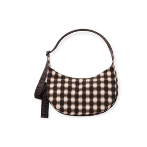 Half-moon shaped shoulder bag with brown and beige checkered pattern and dark brown adjustable strap with logo detail