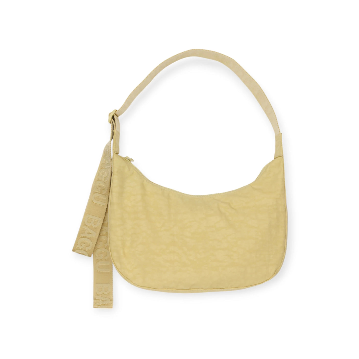 Meet the Baggu Medium Nylon Crescent Bag - Butter, a chic shoulder bag with a bold strap plus an extra "BAGGU" keychain-style strap. It's machine washable, ensuring easy maintenance and day-to-day allure.