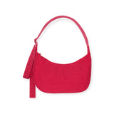 The Baggu Medium Nylon Crescent Bag in Candy Apple features a stylish curved shape and matching strap, capturing eco-friendly elegance.