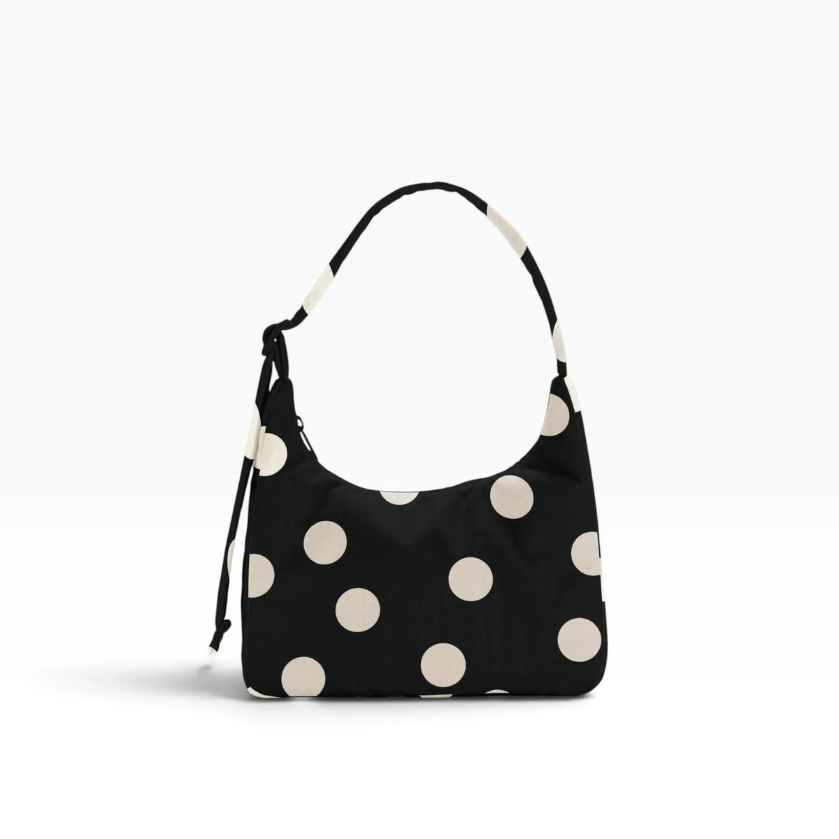 Black mini shoulder bag with cream polka dots and drawstring shoulder strap