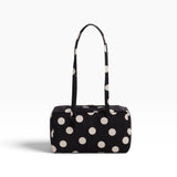 Black nylon bowler bag with cream polka dots, top handles, front zipper pocket.