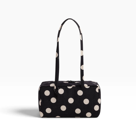 Black nylon bowler bag with cream polka dots, top handles, front zipper pocket.