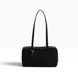 Black nylon bowler bag with studded trim and top handles, front zipper pocket