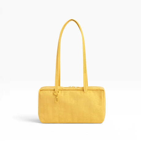 Baggu nylon bowler bag in sunflower yellow with top handles and front zipper detail