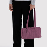Plum nylon bowler bag with top handles and zip closure, side view