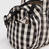 Black-and-cream gingham duffle bag with metal rings, key clip, and adjustable strap