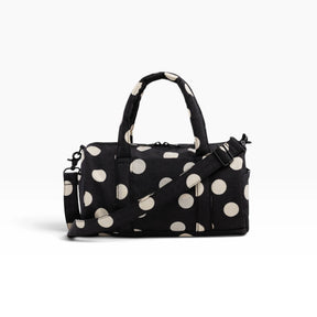 Black and cream polka-dot nylon duffle bag with top handles and crossbody strap