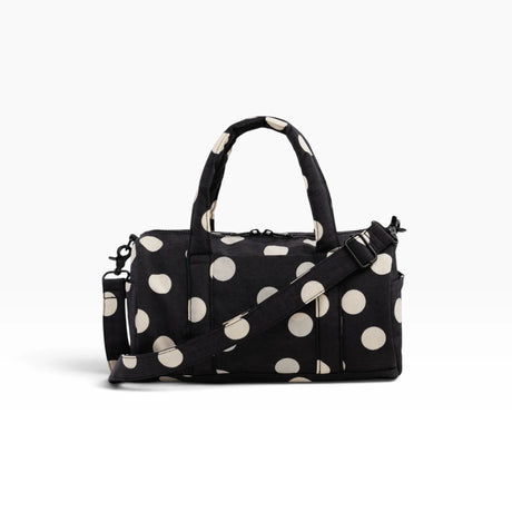 Black and cream polka-dot nylon duffle bag with top handles and crossbody strap