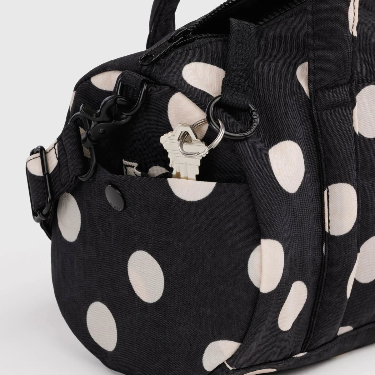 Polka-dot nylon duffle bag with front ring detail and zippered top