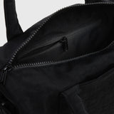 Black nylon duffle bag interior pocket with zip and stitched edge