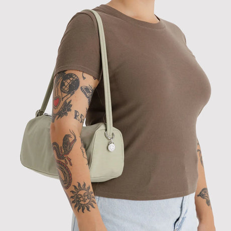 Celadon nylon loaf bag on shoulder with top zipper and silver hardware