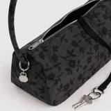 Charcoal nylon bag detail: floral print, metal zipper, key fob on ring