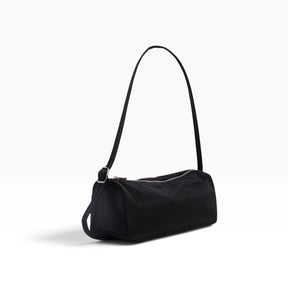 Black nylon loaf shoulder bag with top handle and rounded front seam