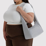 Fog gray nylon tote bag worn on shoulder, roomy open top
