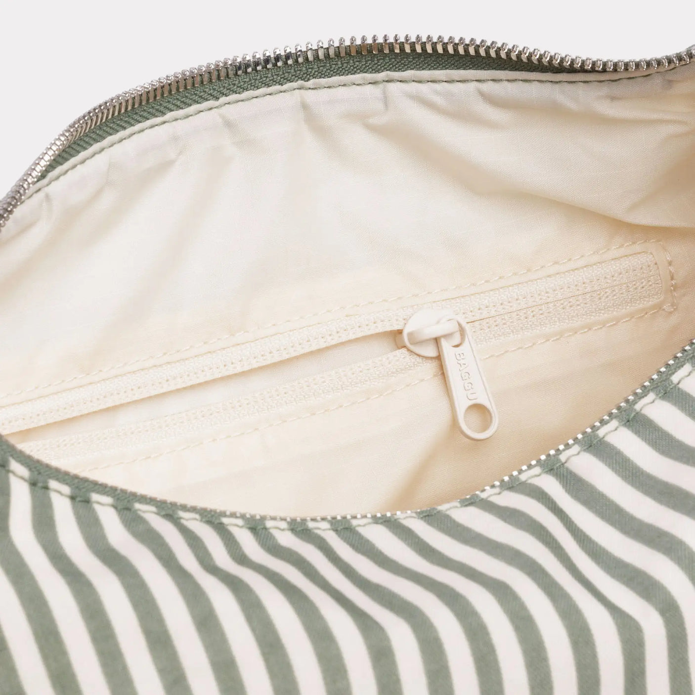 Sage stripe nylon bag interior with zip top and light fabric lining