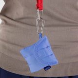 A Baggu Puffy Earbuds Case in cornflower, made from recycled nylon, is attached to a red lanyard with a metal clip.