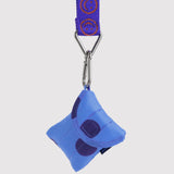 Blue puffy earbuds case keychain with purple circle patches and metal clip