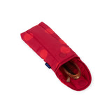 Red puffy glasses case with dark polka dots and snap flap; glasses inside