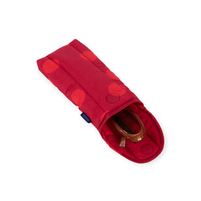 Red puffy glasses case with dark polka dots and snap flap; glasses inside