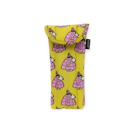 Yellow fabric glasses sleeve from the Baggu brand, showcasing a charming pink penguin design with flap closure and a black "PANTONE" label on the side. As part of the Peanuts x Baggu collaboration, this stylish item complements the playful essence of the Snoopy Puffer collection.