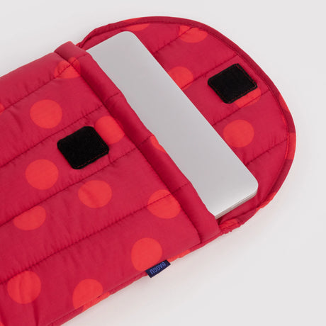 Red polka-dot padded laptop case with black tab label and open sleeve