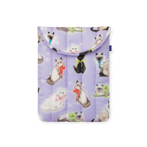 Puffy laptop sleeve in lavender featuring airbrushed cats wearing colorful bows by Sara Rabin with Baggu tag