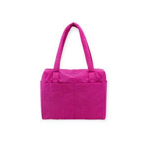 Bright pink fabric tote bag with dual shoulder straps and front slip pockets on white background