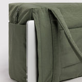 Olive green cloud carry-on tote bag with suitcase sleeve and front zip pocket, close-up