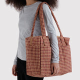Houndstooth carry-on bag with carry handles, tan and dark red pattern