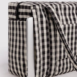 Baggu small carry-on bag in black-and-cream gingham, side panel and fastening strap