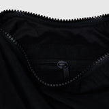 Black nylon crescent bag interior with zipper and stitched logo patch