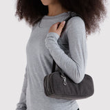 Small washed black denim bowler bag carried on shoulder with top zipper