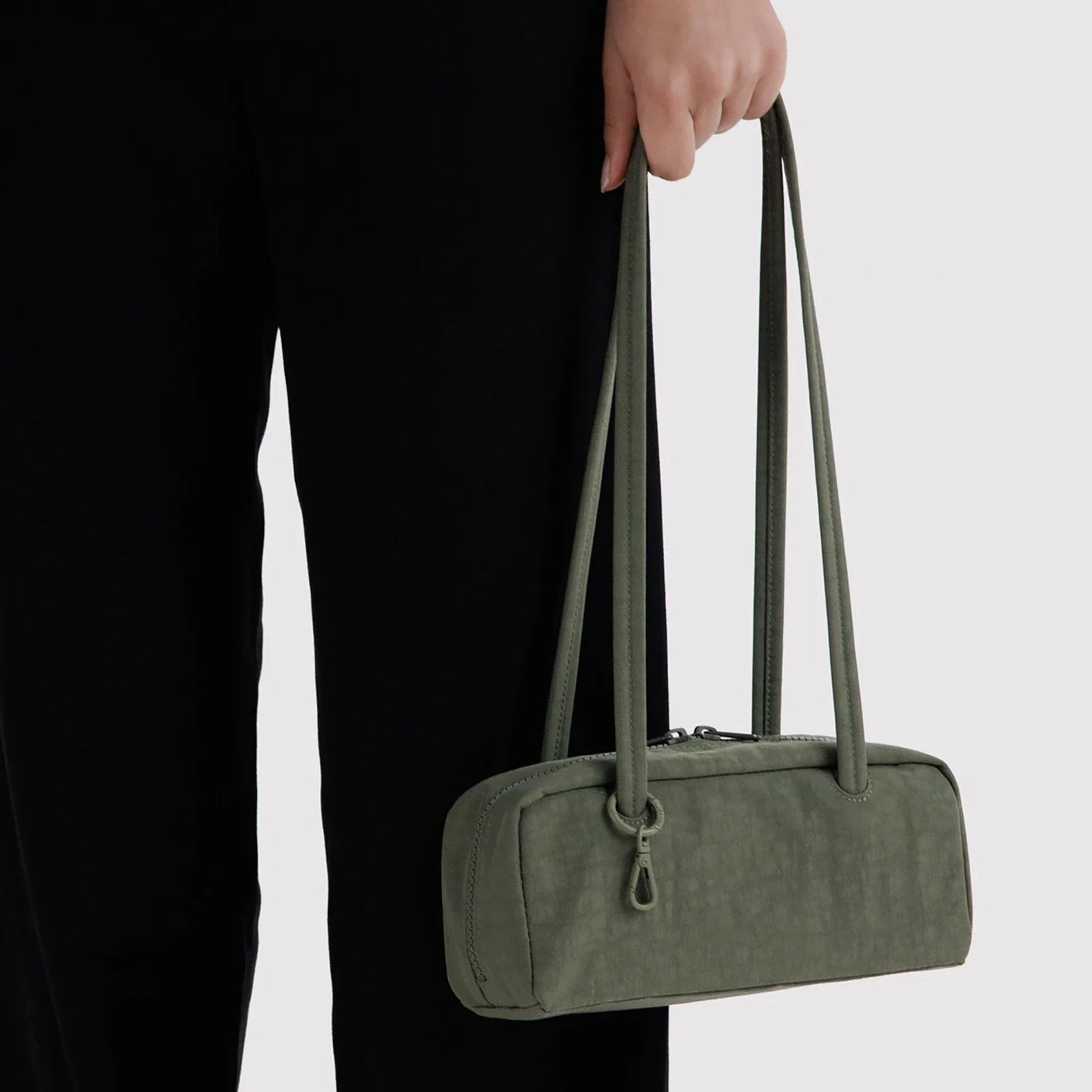 Olive small bowler bag with two top handles and zipper closure.