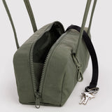 Olive small bowler bag with open zip, black-lined interior, and visible keys.