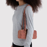 Small houndstooth bowler bag with long strap and top handles, tan and burgundy
