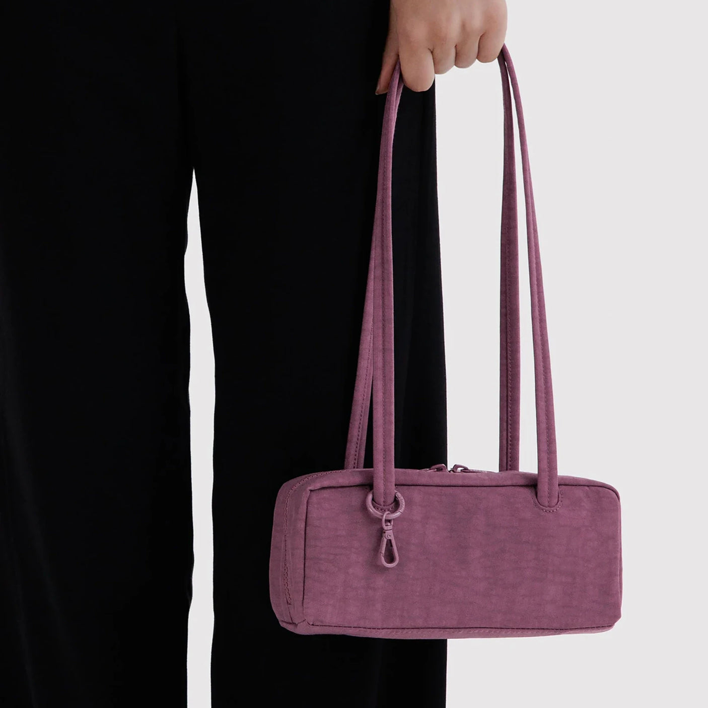 Small bowler bag in plum with two top handles and zip closure