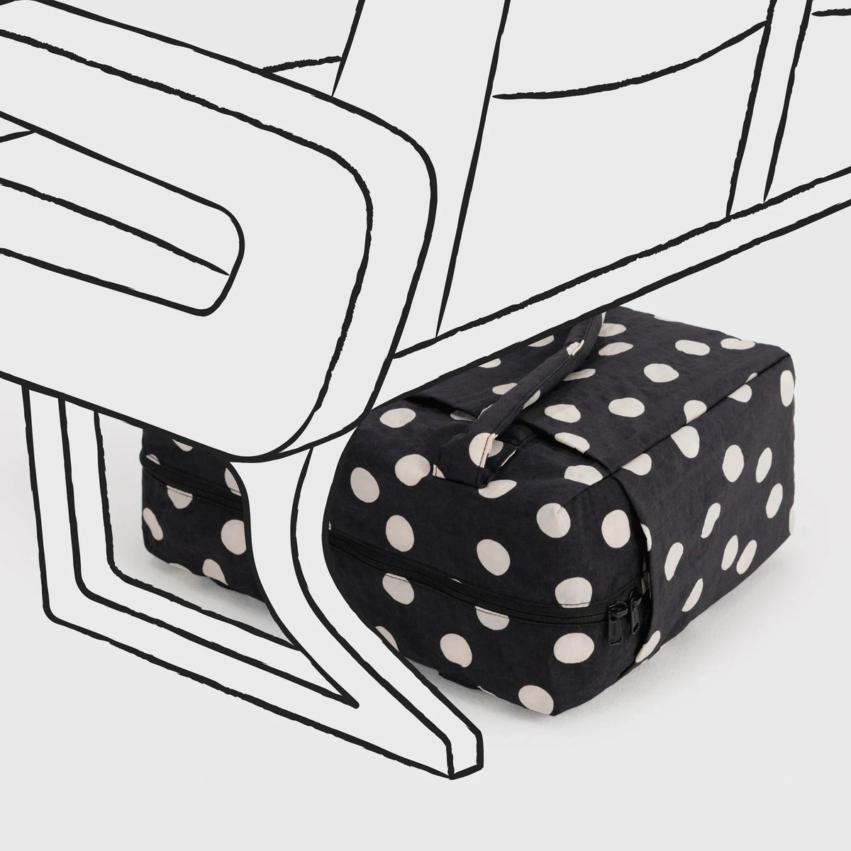 Black polka-dot bag with cream dots, rolled shape with tie strap detail