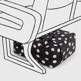 Black polka-dot bag with cream dots, rolled shape with tie strap detail