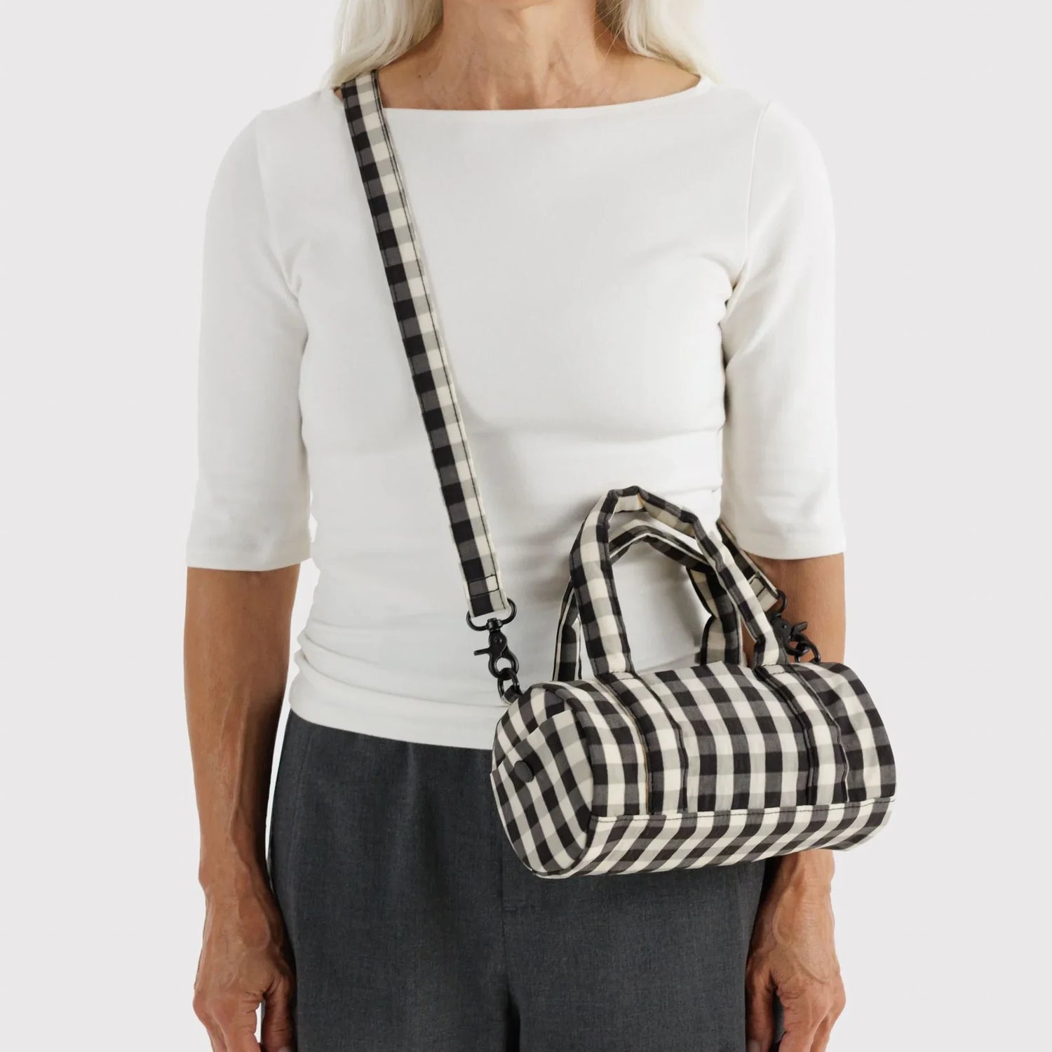 Small duffle bag, black-and-cream gingham, worn with shoulder strap
