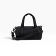 Black nylon small duffle bag with top handles, zip closure, and crossbody strap