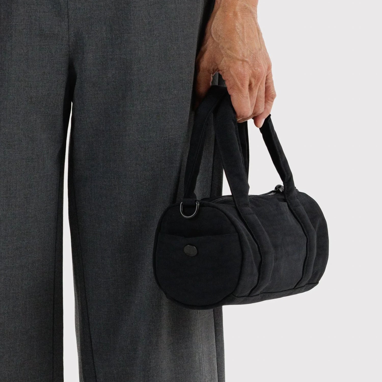 Black nylon small duffle bag with side pocket and top carry handle
