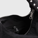 Black nylon bag interior with zipper and metal pull at top opening
