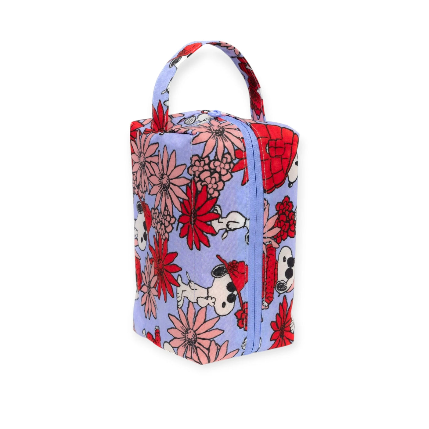 Introducing the Peanuts x Baggu - Floral Snoopy Makeup & Toiletry Bag by Baggu. This eco-friendly bag features a delightful floral design adorned with charming Snoopy illustrations. It includes a convenient top handle and secure zipper closure, making it perfect for storing all your essentials in style.