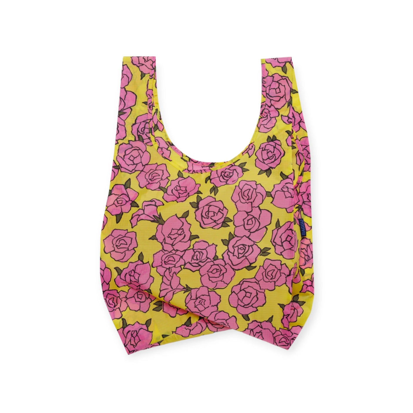 The Baggu Standard Reusable Bag - Rose, from the brand Baggu, showcases a lively print of pink roses on a yellow background against a plain white backdrop, reflecting eco-consciousness in every fashionable fold.