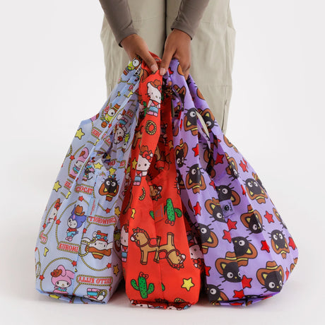 Printed drawstring bag set with three patterned totes in red, purple, and light blue