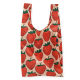 Introducing the Big Baggu Bag - Strawberry from Baggu. This oversized tote, crafted from recycled nylon with a charming strawberry print on a beige background, is both eco-friendly and stylish, making it the perfect reusable shopping bag for carrying all your essentials.